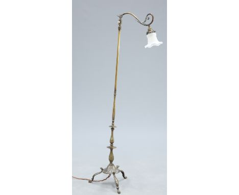 AN EDWARDIAN BRASS STANDARD LAMP, the scrolling leaf capped branch supporting a frosted glass shade, the tubular and knopped 
