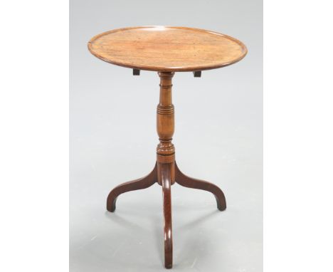 A GEORGE III MAHOGANY TRIPOD TABLE, the dished circular top raised on a ring turned stem continuing to downswept legs. 69cm h