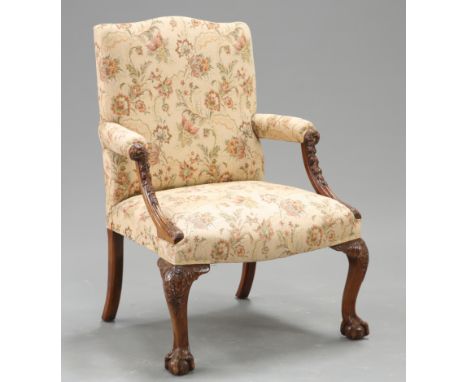 A CHIPPENDALE STYLE MAHOGANY GAINSBOROUGH CHAIR, raised on foliate carved cabriole legs terminating in ball and claw feet. He