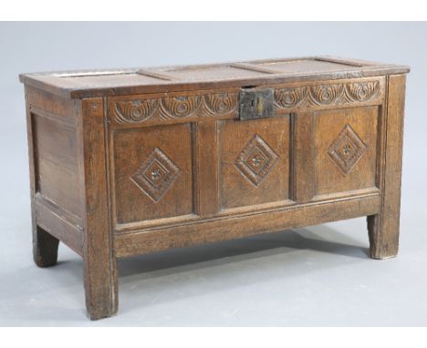 A LATE 17TH CENTURY OAK COFFER, with three panel lid and front, the front carved with lozenges. 68.5cm high by 124cm wide by 