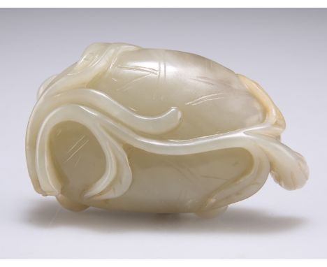 A CHINESE JADE 'LOTUS' BRUSH WASHER, carved as a rolled lotus leaf with a seed pod issuing from thick stems, 7.5cm wide; toge