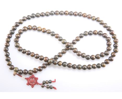 CHINESE WOODEN PRAYER BEADS, threaded to a red silk cord with a jade bead, overall length of beads 113cm; together with A CHI