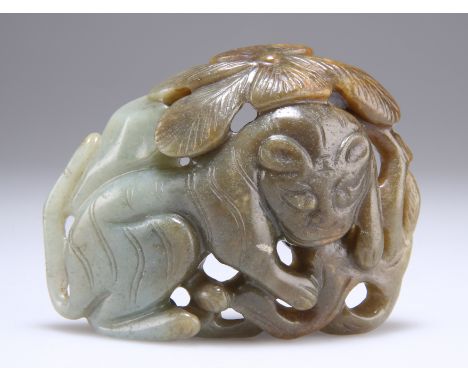 A LARGE CHINESE JADE BELT BUCKLE, pierced and carved with a lion. 8.5cm by 6.5cm