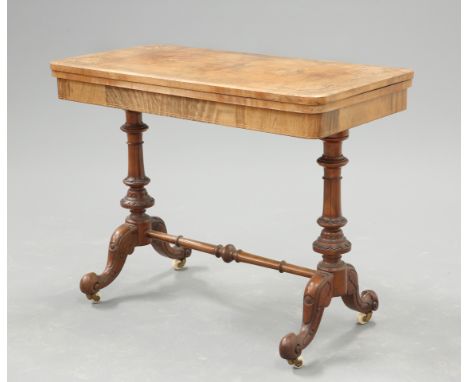 A VICTORIAN INLAID WALNUT FOLDOVER CARD TABLE, the quarter veneered rectangular top with foliate and string inlay, raised on 