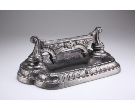 A VICTORIAN CAST IRON BOOT SCRAPER, of fancy bracket form to a shaped rectangular base. 15cm high by 37cmThe absence of a Con