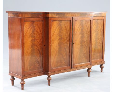 A REGENCY STYLE CROSSBANDED MAHOGANY CHIFFONIER, with two pairs of flame mahogany panel doors, enclosing shelves and a slide,