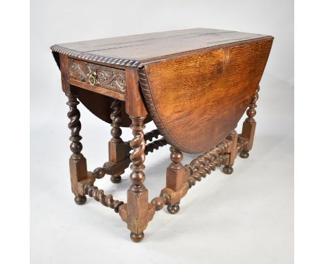 A Mid 20th Century Oak Drop Leaf Gate Leg Oval Top Dining Table with Carved Border and Barley Twist Supports and Stretchers, 