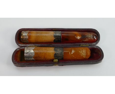 Two amber  Meerschaum and silver mounted cigar or cigarette holders: One in original case, largest measures 9.5cm long. 