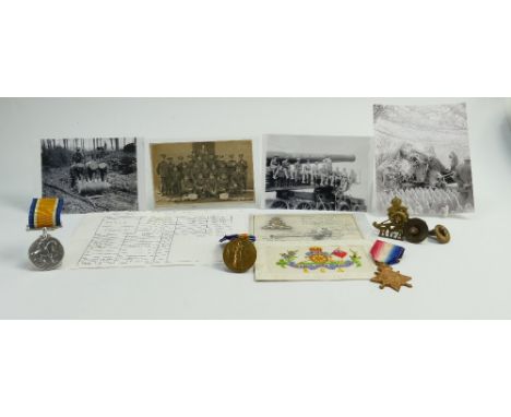A group of medals awarded to Gnr T.W.Bailey R.G.A: Three first world war medals together with photographs, cap badges and sil