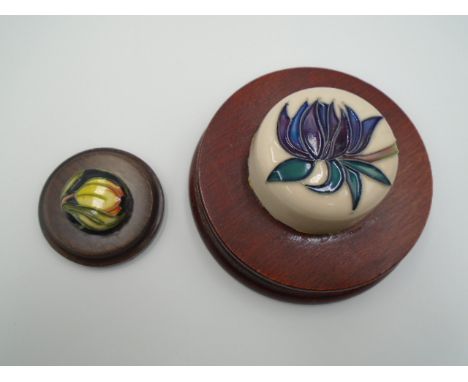 Moorcroft pottery ruby red pattern ginger jar lid paperweight together with a Figaro pattern miniature ginger jar lid paperwe