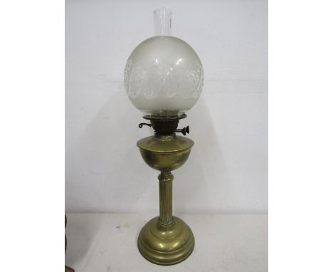 A brass based oil lamp with globe and funnel