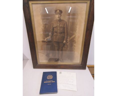 A photo of a soldier along with Northamptonshire regiment 7th battalion book and a letter sent with medals to the soldiers wi