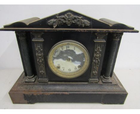 A vintage metal mantel clock
