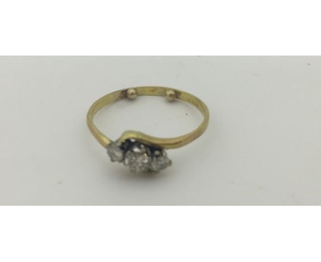 A gold three-stone diamond ring