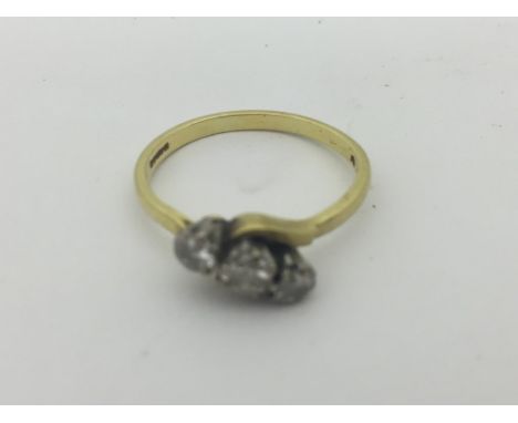 A gold three-stone diamond ring