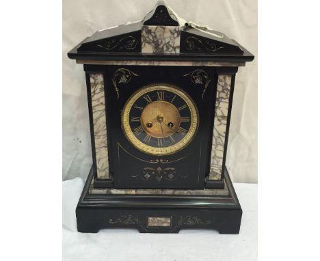 A black slate mantel clock with eight-day movement striking on gong: retailer to the dial 'Oetzman & Co, Hampstead Road, Lond