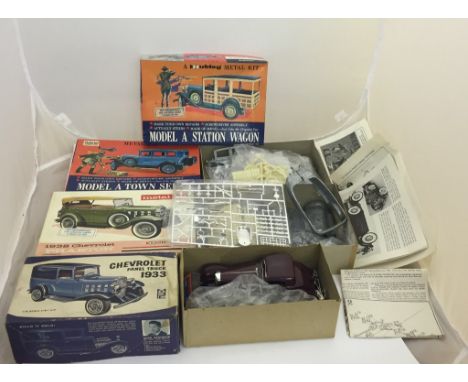 A collection of model kit cars comprising a model of station wagon, a model A town Sedan, a Chevrolet 1932 Phaeton, by Hubley