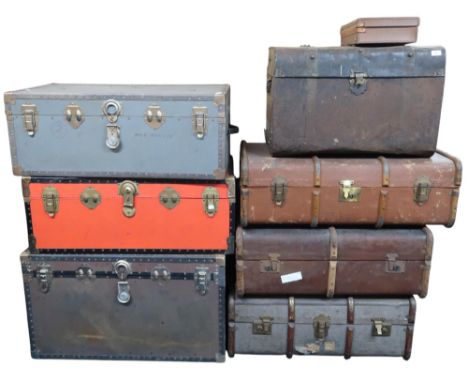 A mixed lot of trucks to include three steamer trunks, three wood bound travel trunks, metallic trunk and a small briefcase (