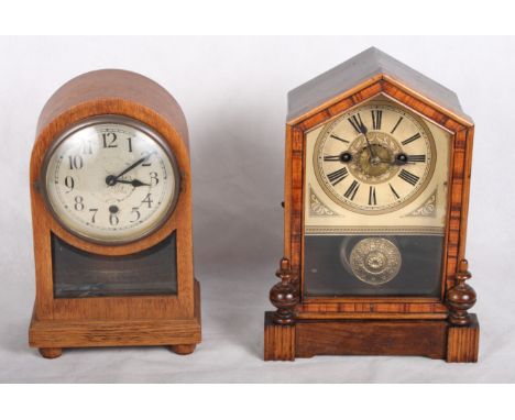 An American shelf clock with alarm enclosed glazed door and another mantel clock in arched top case inset bevelled glass pane