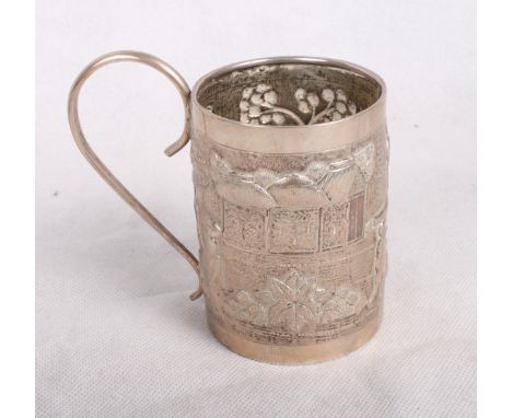 An Indian white metal mug embossed with figures in a landscape and a Chinese silver napkin ring, 4.8oz troy approx