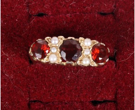 A 9ct gold, garnet and seed pearl dress ring