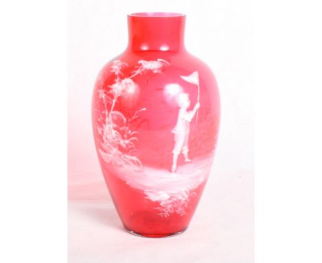 An oviform ruby glass vase with "Mary Gregory" white enamel decoration of a child with a butterfly net