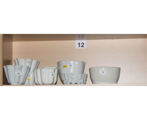 Three Shelley white china jelly moulds and four similar jelly and ring moulds