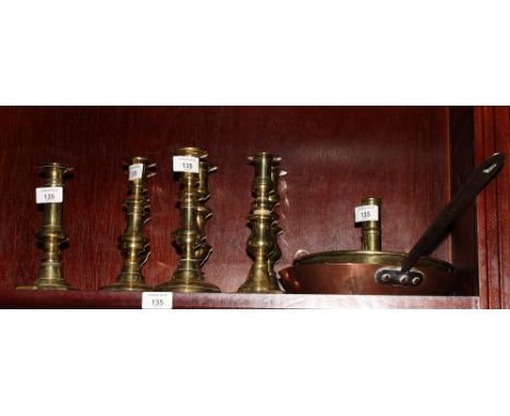 A set of four 19th Century brass ejector candlesticks on circular bases, 8" high, a pair of similar candlesticks on square ba