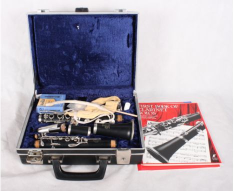 A clarinet, in case, with instruction books