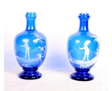 A pair of 19th Century blue glass bottle-shaped vases with "Mary Gregory" white enamel decoration of children, 9" high