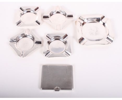 A silver cigarette case with engine turned decoration, a silver ashtray and a set of four smaller silver ashtrays with engine