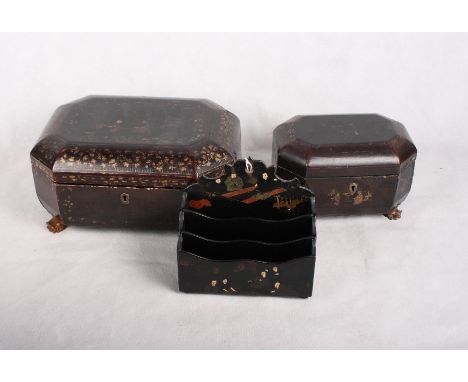 A 19th Century black lacquered workbox decorated in gilt with chinoiserie, a similar two compartment tea caddy and a papier-m