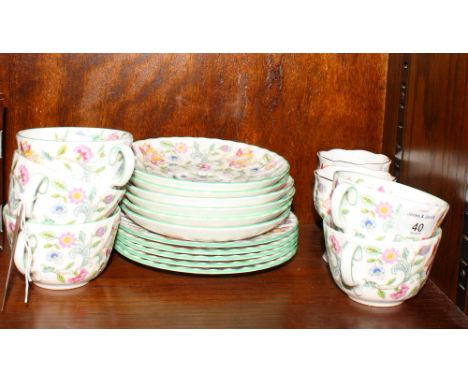 A Minton's "Haddon Hall" part tea service comprising five cups, five side plates, six saucers and two pedestal vases