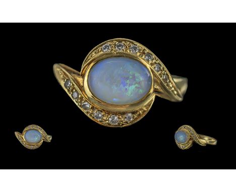 Ladies - Attractive 14ct Gold Opal and Diamond Set Ring, marked 585 - 14ct to shank, the oval shaped opal surrounded by 12 sm