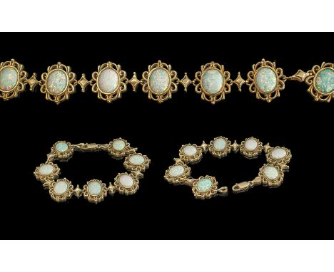 Ladies - attractive 9ct gold 7 stone opal set bracelet, all opals set in ornate open-worked setting. full hallmark for 9.375.