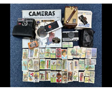 A Collection of Cameras and Cigarette Cards cameras to include Brownie, Kodak, Canon, Polaroid instant camera, a hardback Cam