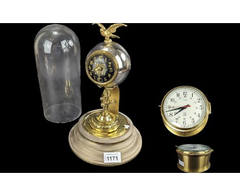 Two Vintage Clocks, comprising a pedestal mantle clock with an eagle pediment, black face with gilt markers beneath a glass d