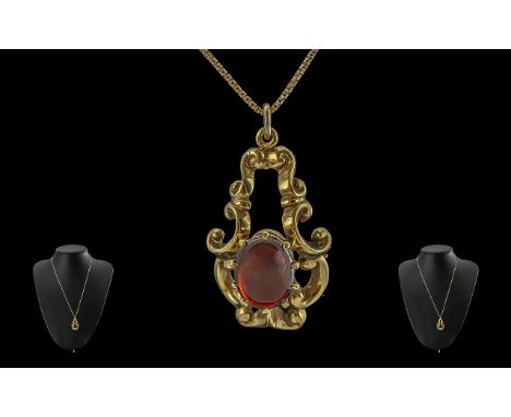 Ladies 9ct gold single stone garnet set ornate pendant with attached 9ct gold chain. both chain and pendant marked for 9ct. t