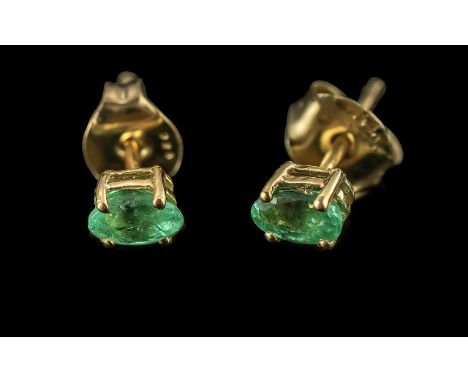 Pair of Emerald Stud Earrings, the oval cut emeralds of excellent colour, set in classic style, with post and push back fitti