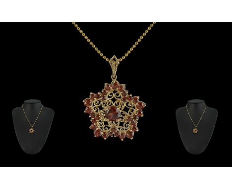 Ladies 14ct Gold Beverley Hills Fancy Open worked Pendant, set with orange garnets.  Attached to a 14ct Gold quality chain.  
