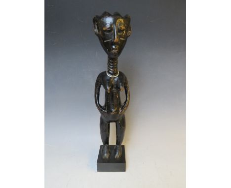  A CARVED AFRICAN TRIBAL STATUE, depicting a standing female, on later plinth, H 34 cm (excl. plinth)