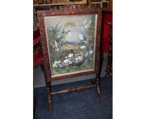 A 19TH CENTURY CARVED OAK FIRESCREEN WITH INSET WATERCOLOUR, carved with trailing vine leaves and grapes, raised on turned su