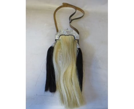 A HORSE HAIR SPORRAN WITH CELTIC EMBELLISHMENT