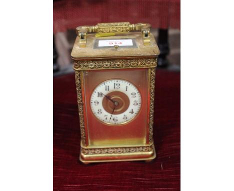A LARGE ORNATE GONG STRIKE REPEATER CARRIAGE CLOCK, the gilded case having floral cast embellishment gilded dial plate and co