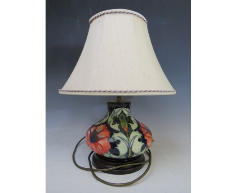 A MODERN MOORCROFT POPPY TABLE LAMP WITH SHADE, designed by Rachel Bishop, of bulbous form,on a turned wooden base, H 27 cm (
