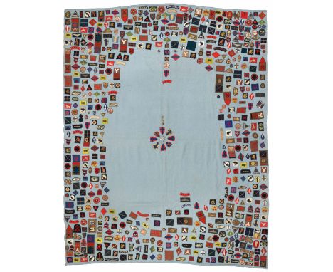 Large blanket covered in WW2 cloth formation signs and shoulder titles.A splendid vast collection of cloth formation signs as