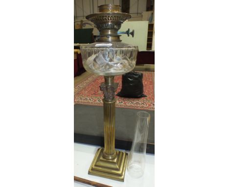 A Victorian brass Corinthian column oil lamp with clear cut-glass reservoir, 55cm high.