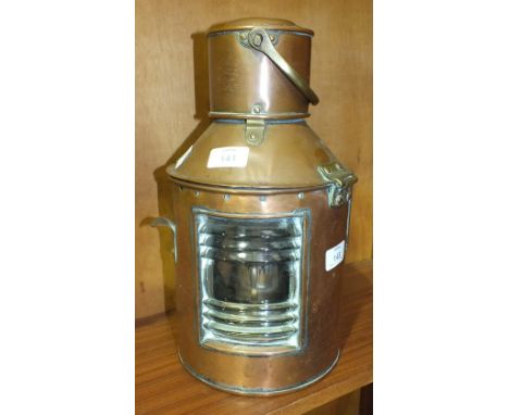 A ship's copper and brass lamp with oil lamp burner and carrying handle, 36cm high.