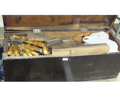 A painted tool box, 92cm wide, containing a collection of hand tools, chisels, saws and a small metal box of tools and miscel