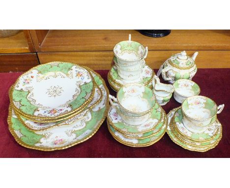 A Coalport ceramic part tea service decorated with gilt, floral sprays and Victoria green panels, approximately 25 pieces.